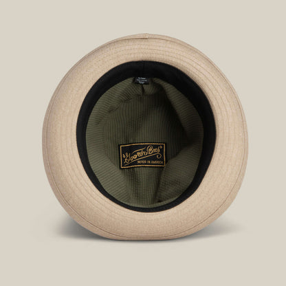 The Goorin Bros. Big Stepper is a beige statement hat shown from above with its inner lining and a black and gold "Made in America" label visible—an elegant fashion accessory for any wardrobe.
