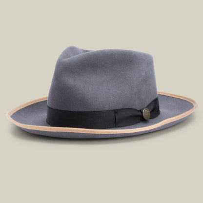 The River Gray by Goorin Bros. is a wide-brimmed fedora hat in grey, expertly crafted from premium merino wool with a black band and light brown edge, made in the USA and showcased against a neutral background.