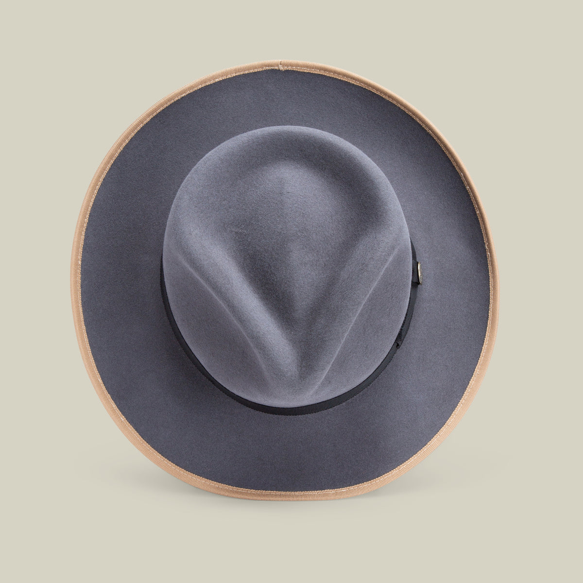The River Gray by Goorin Bros. is a wide-brimmed hat, crafted from premium merino wool with a tan edge, displayed against a plain light background and viewed from above. Made in America, this fedora blends timeless style with exceptional craftsmanship.