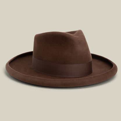 The Colonel Pierce by Goorin Bros. is a brown felt fedora with a wide pencil curl brim, matching dark brown ribbon band, and classic teardrop crown, shown against a plain light background.