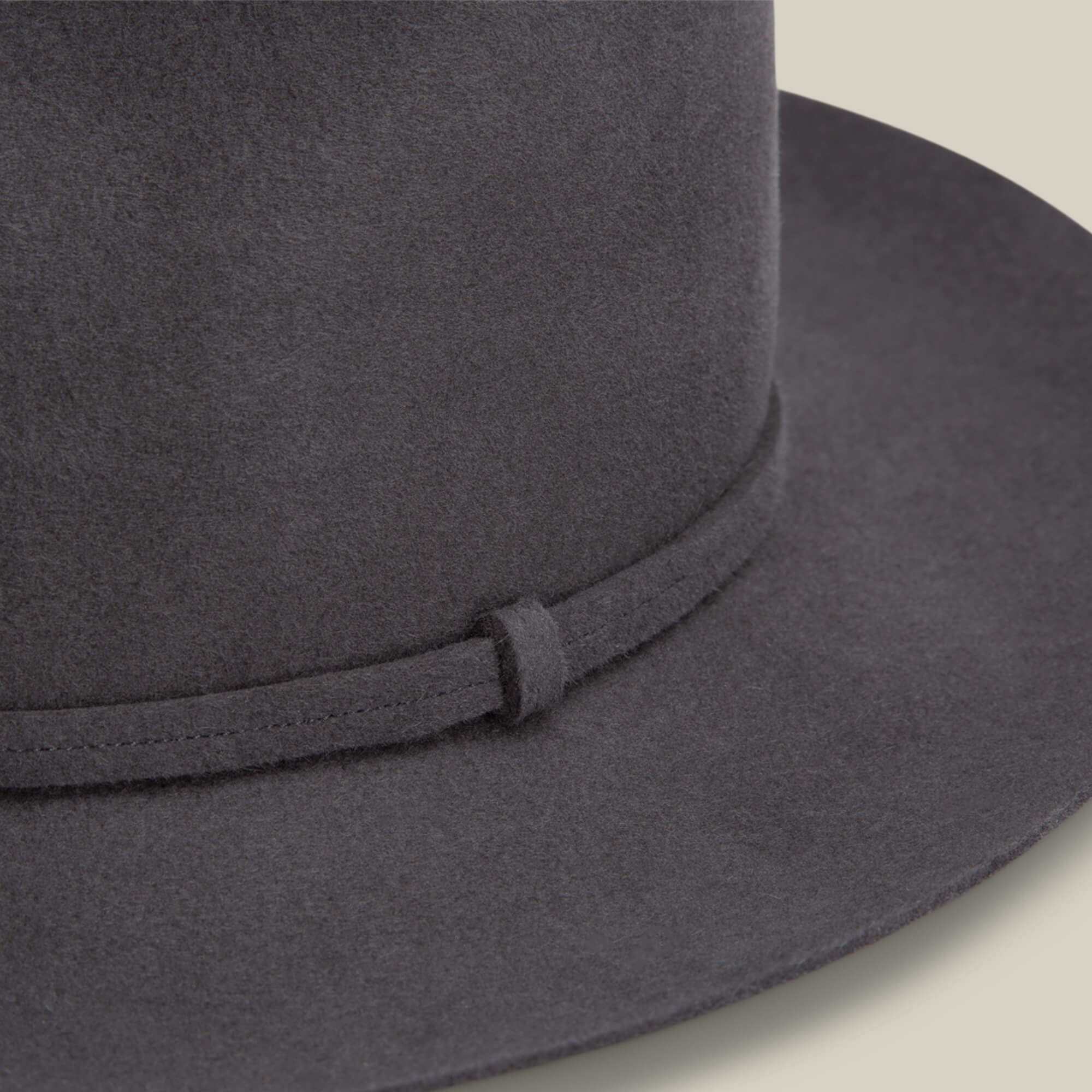 Close-up of the Night Hawk fedora by Goorin Bros., featuring a dark grey felt teardrop crown and matching narrow band, set against a neutral background.