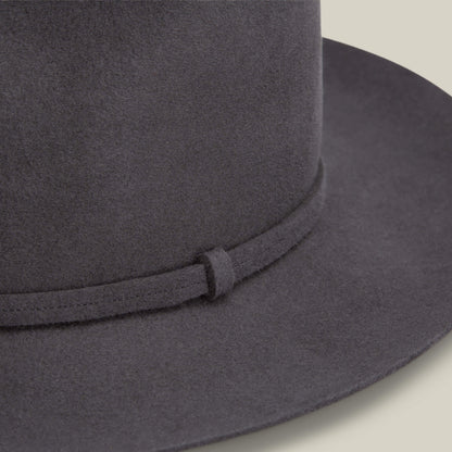Close-up of the Night Hawk fedora by Goorin Bros., featuring a dark grey felt teardrop crown and matching narrow band, set against a neutral background.