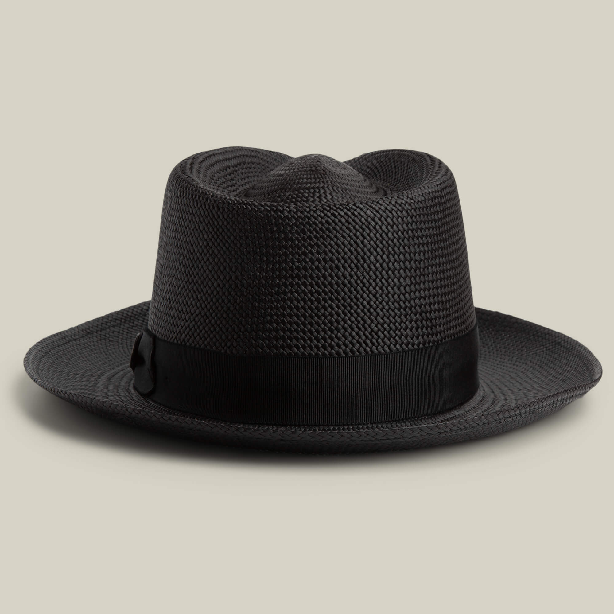 The John Sr. by Goorin Bros. is a black toquilla teardrop fedora hat with a wide brim and black ribbon band, offering 50 UPF sun protection, displayed on a neutral background.