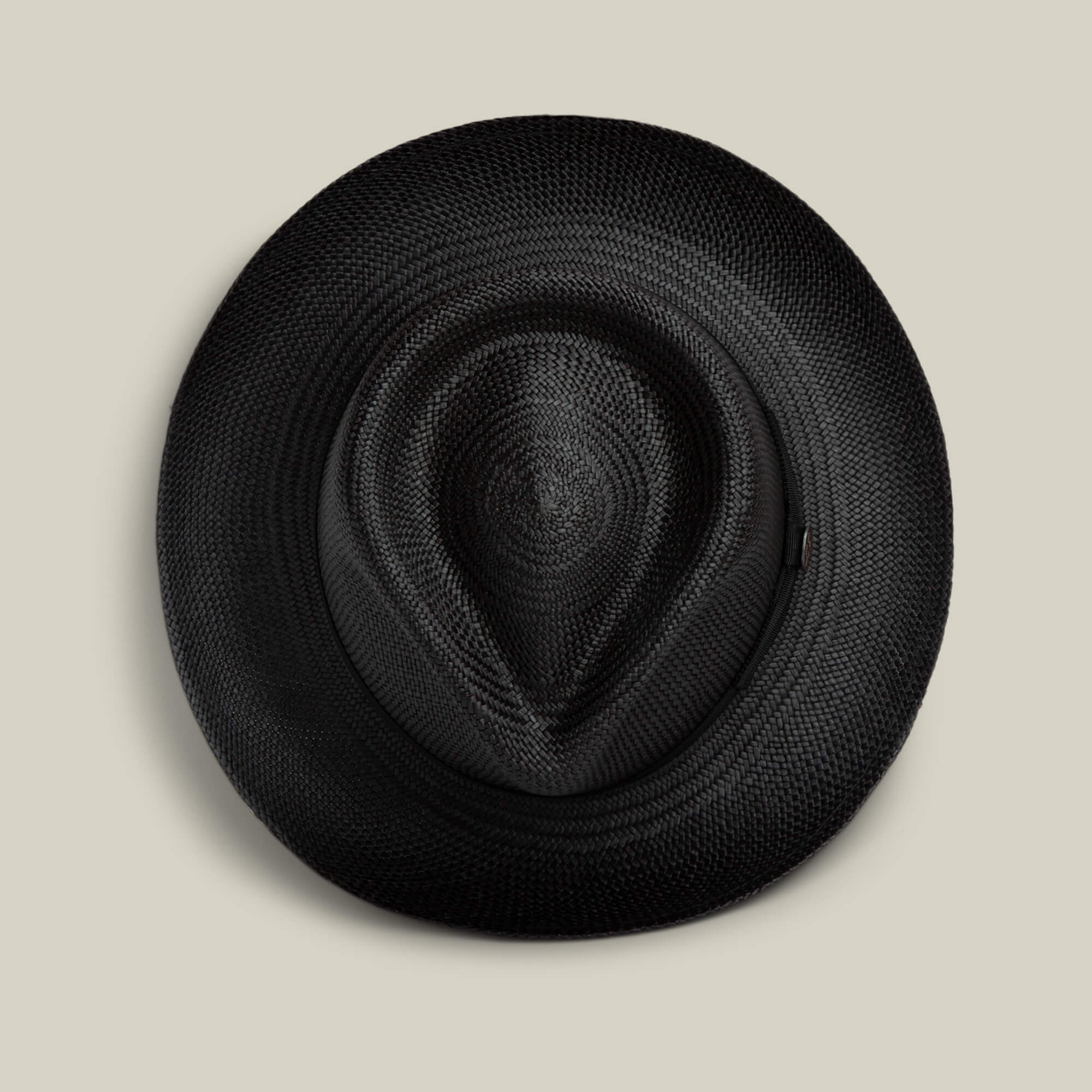 The Goorin Bros. John Sr. black toquilla fedora is shown from above, with its brim and crown visible against a light beige background, providing stylish sun protection with a 50 UPF rating.