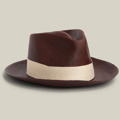 The Goorin Bros. John Sr. is a brown toquilla teardrop fedora hat with a wide, light band and 50 UPF sun protection, displayed against a plain, light background.