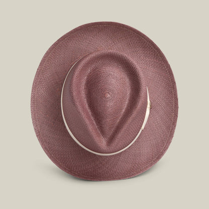 A top view of the John Sr. maroon toquilla teardrop fedora by Goorin Bros., featuring a wide brim and light band, set on a beige background—an elegant 50 UPF sun-protective choice.