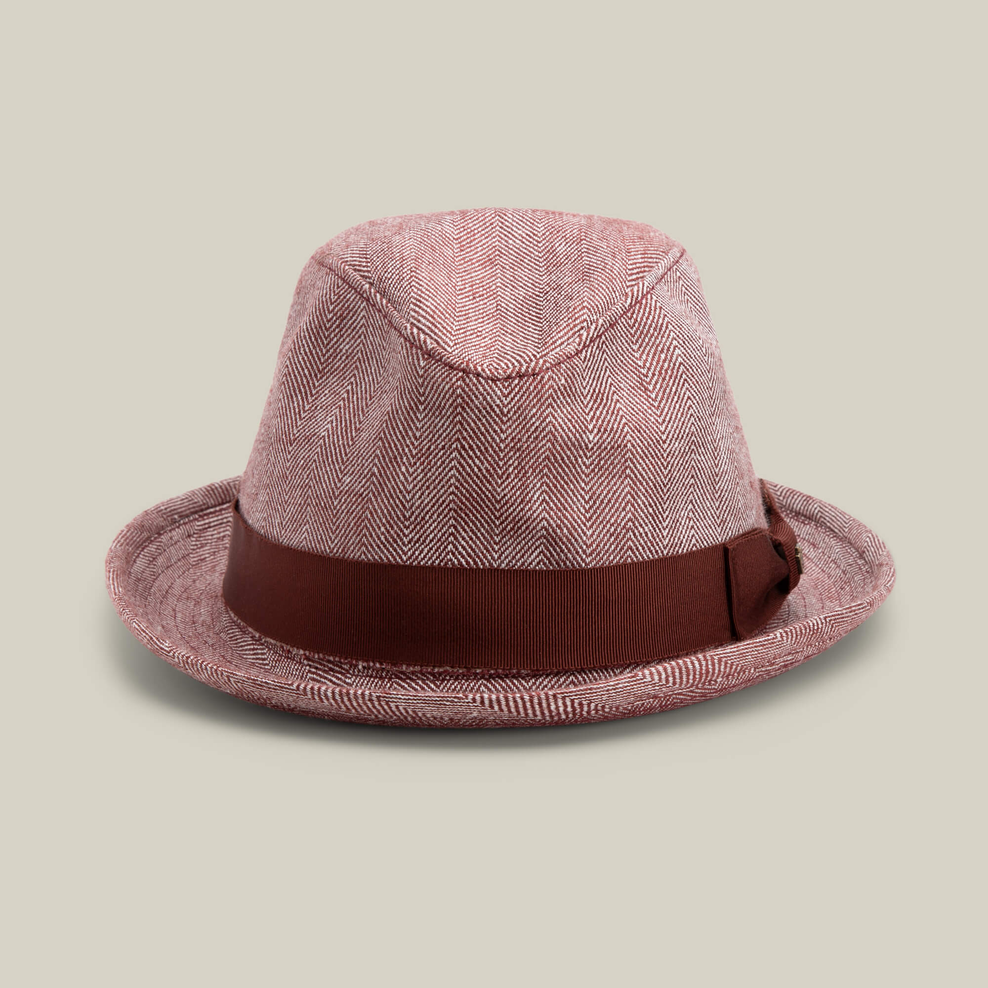 The Goorin Bros. Zig Zag Big Stepper fedora in DESIRE features a structured herringbone pattern and a wide brown band, shown against a plain beige background.