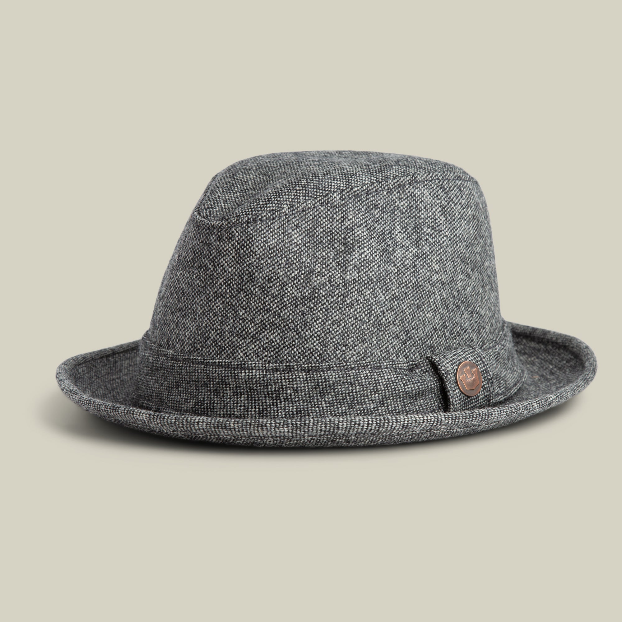 The Goorin Bros. Shady Tweed Fedora features a gray textured finish, a short brim, and a small round brown emblem on the band, shown against a neutral background.