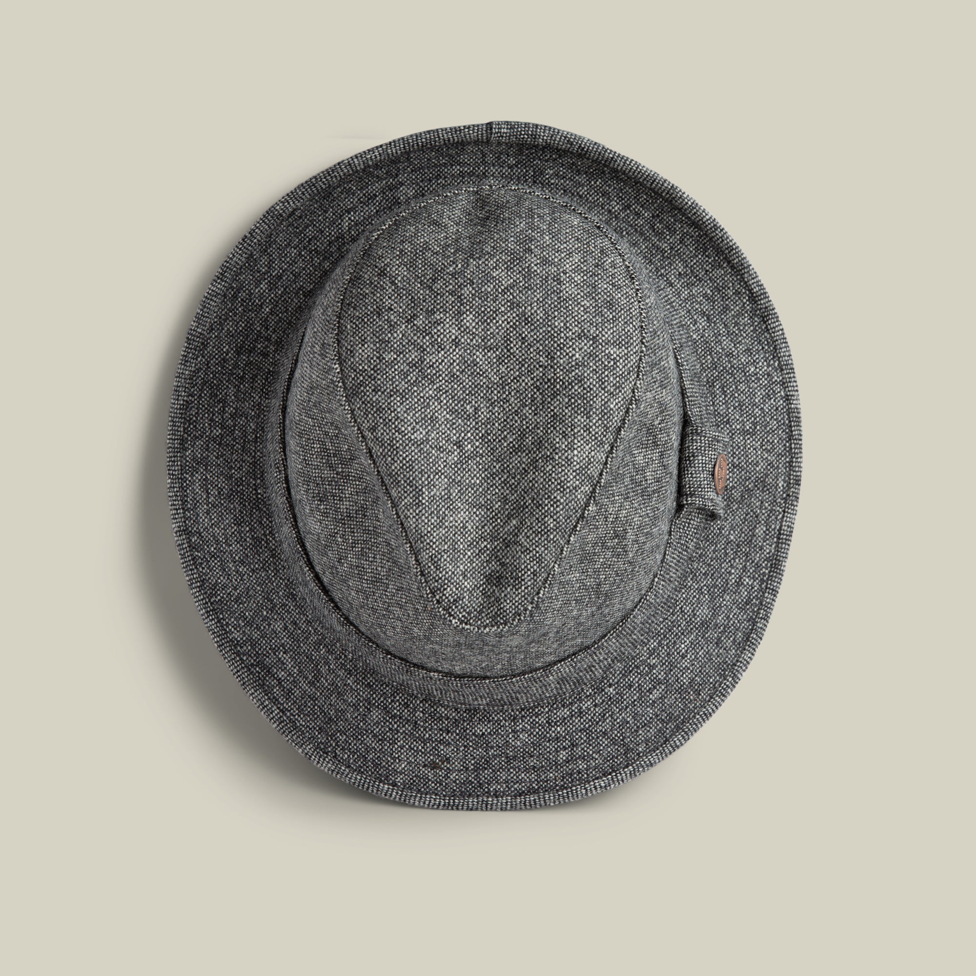 The Shady Tweed Fedora by Goorin Bros., in gray Shetland wool with a narrow brim, is shown from above on a plain beige background.