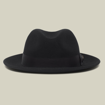 Dean the Butcher by Goorin Bros. is a black, American-made fedora with a wide brim and sleek grosgrain hatband, showcased against a plain light background.