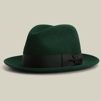 Introducing “Dean the Butcher” by Goorin Bros.—an American-made fedora in GUARD, featuring a wide black ribbon band and bow. Stylishly displayed on a neutral background, this versatile all-season hat is perfect for any occasion.