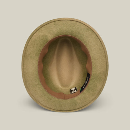A top-down view of the Dean the Butcher fedora by Goorin Bros., featuring olive green felt, a brown inner band, and a small black label with white text inside.