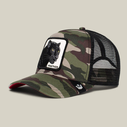 The Panther by Goorin Bros. is a camo trucker hat with a black mesh back, front patch of a black panther and "PANTHER" text—ideal for adventures on The Farm or channeling your inner Ninja Kitten.