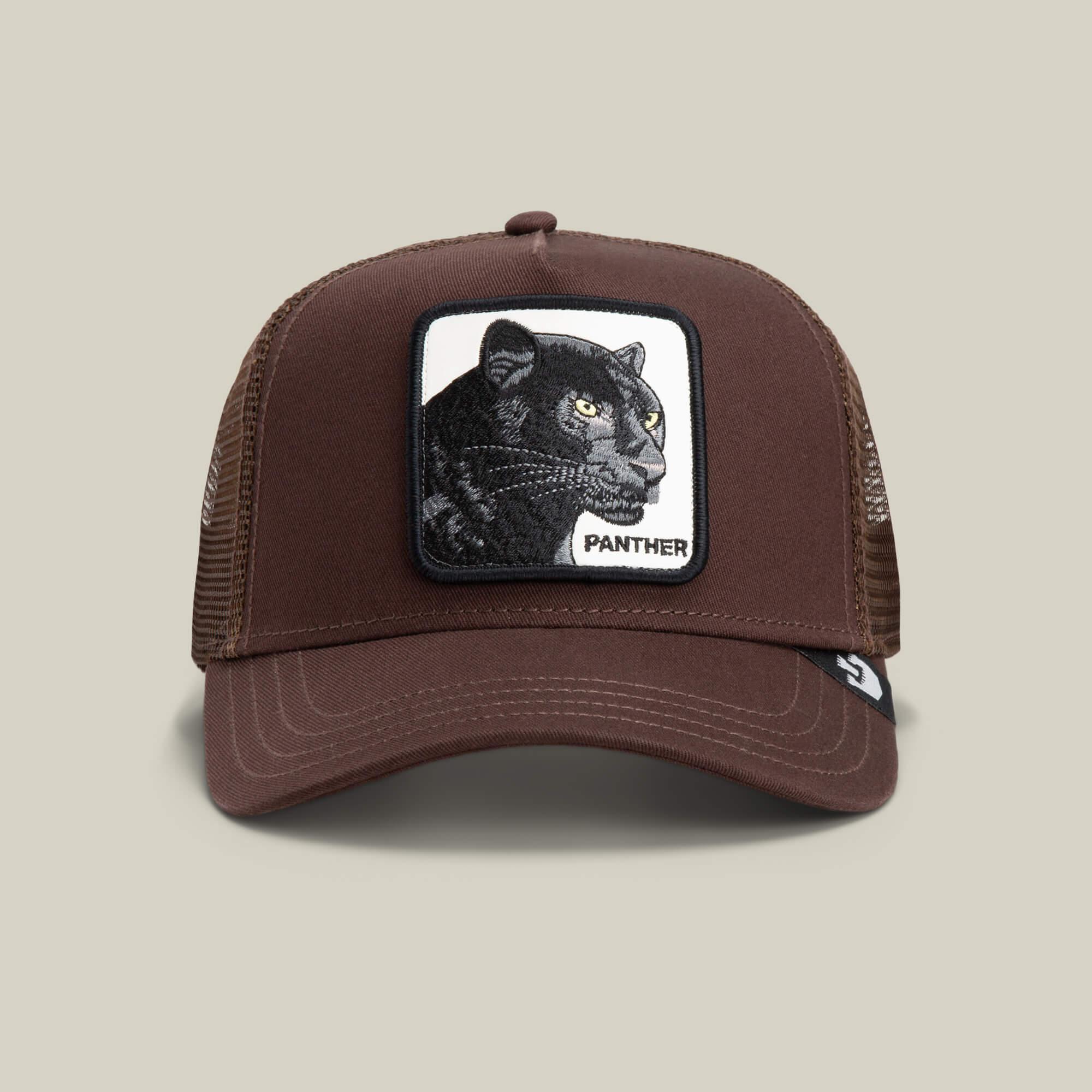 Brown mesh trucker baseball hat by Goorin Bros., called The Panther, featuring a rectangular patch with an embroidered black panther and the word "PANTHER" on the front.