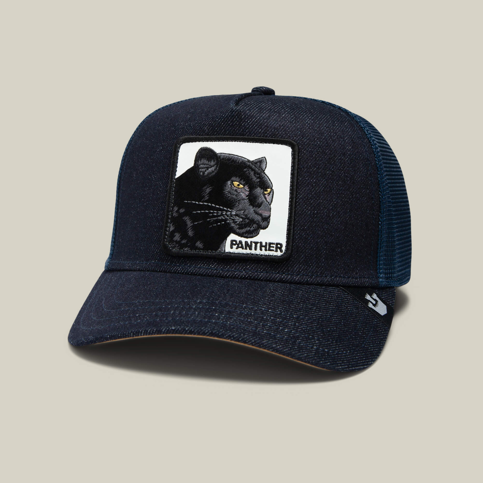 The Panther by Goorin Bros. is a dark blue mesh trucker baseball hat with a sewn patch of a black panther and "PANTHER" on the front—ideal for fans of The Farm or those wanting bold Ninja Kitten flair.