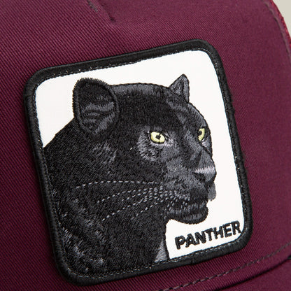 A close-up of The Panther trucker hat by Goorin Bros., showing a maroon cap with a patch featuring an embroidered black panther and “PANTHER” in black letters.