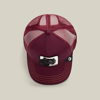 The Panther by Goorin Bros. is a maroon mesh trucker baseball hat with a black panther patch on the front, yellow stitching on the bill, and a small black side tag.