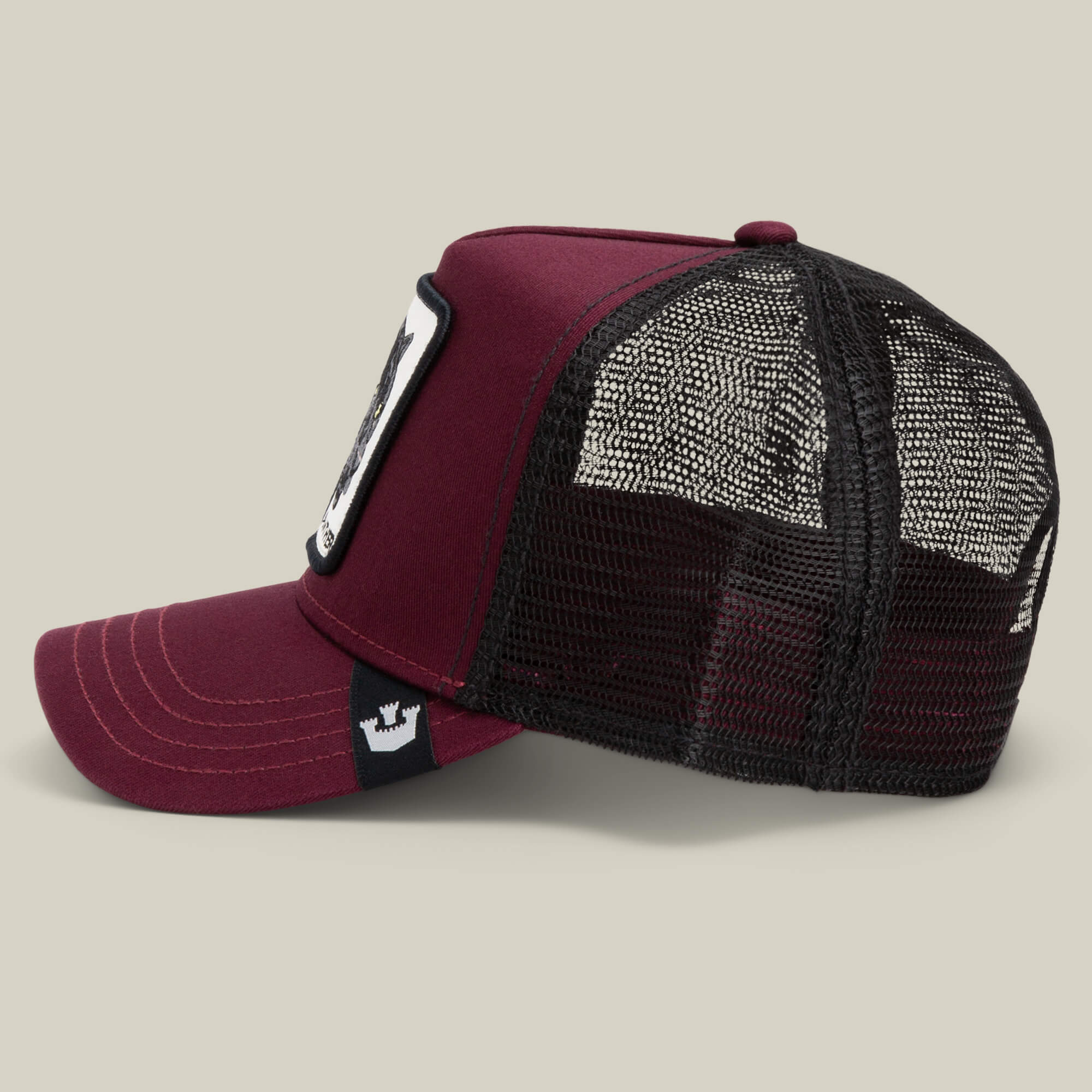The Panther by Goorin Bros. is a maroon and black mesh trucker baseball hat with a front patch and a small crown logo under the bill, shown on a neutral background. Part of The Farm collection.