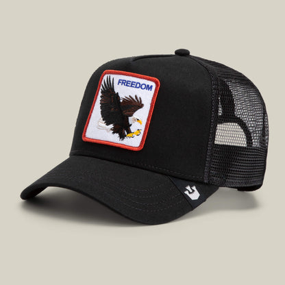 The Farm's The Freedom Eagle is a black mesh trucker hat featuring an embroidered eagle and FREEDOM patch—perfect for making a bold statement with unique style.