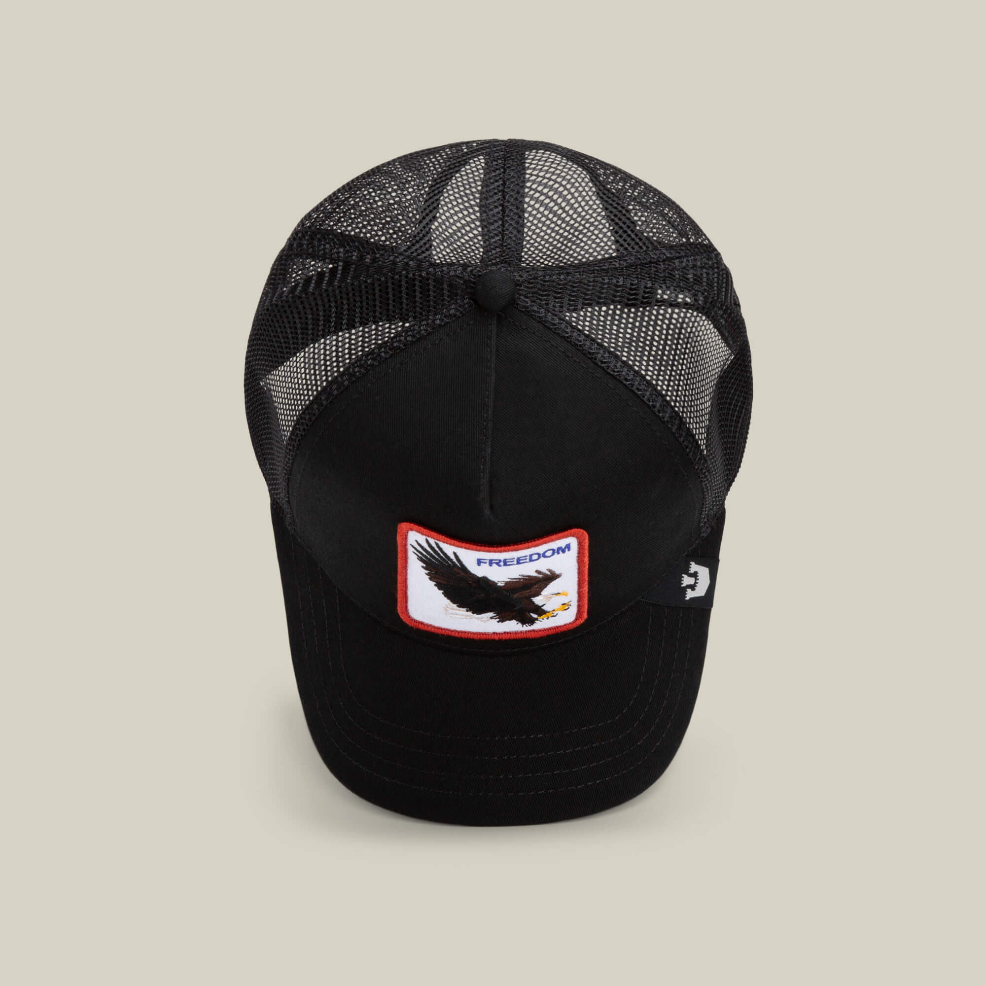 The Farm's The Freedom Eagle is a black mesh trucker cap with a front patch showing an eagle and the word FREEDOM in red—a bold way to express your style and keep your distance.