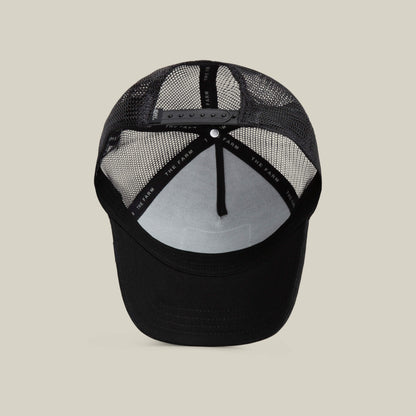 The Freedom Eagle by The Farm is a black trucker hat with a breathable mesh back, adjustable snap closure for a secure fit, and a black sweatband to keep sweat at bay.