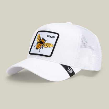 The Farm’s "The Queen Bee" is a white mesh trucker cap featuring a patch with a yellow bee and QUEEN embroidered above—ideal for anyone ready to slay and wear their crown with pride.