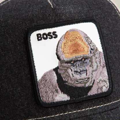 A close-up of The Farm's "The Boss" cap in dark fabric, showing a stitched patch with an embroidered 800 pound gorilla and the word "BOSS" in black text.