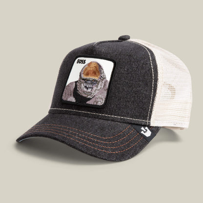 The Boss by The Farm is a dark gray and white mesh trucker cap featuring a patch with an 800-pound gorilla and "BOSS" on the front—ideal for bold style. Add it to your cart now!.