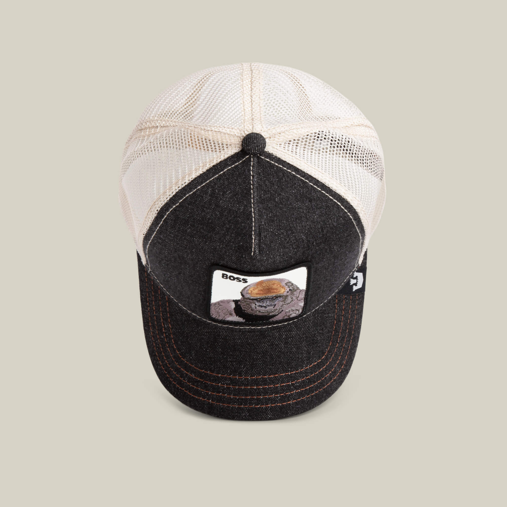 The Farm's "The Boss" is a black and beige mesh baseball cap with a lizard-in-cap patch and "BOSS" above it—an 800-pound gorilla statement piece. Add to cart for standout style.