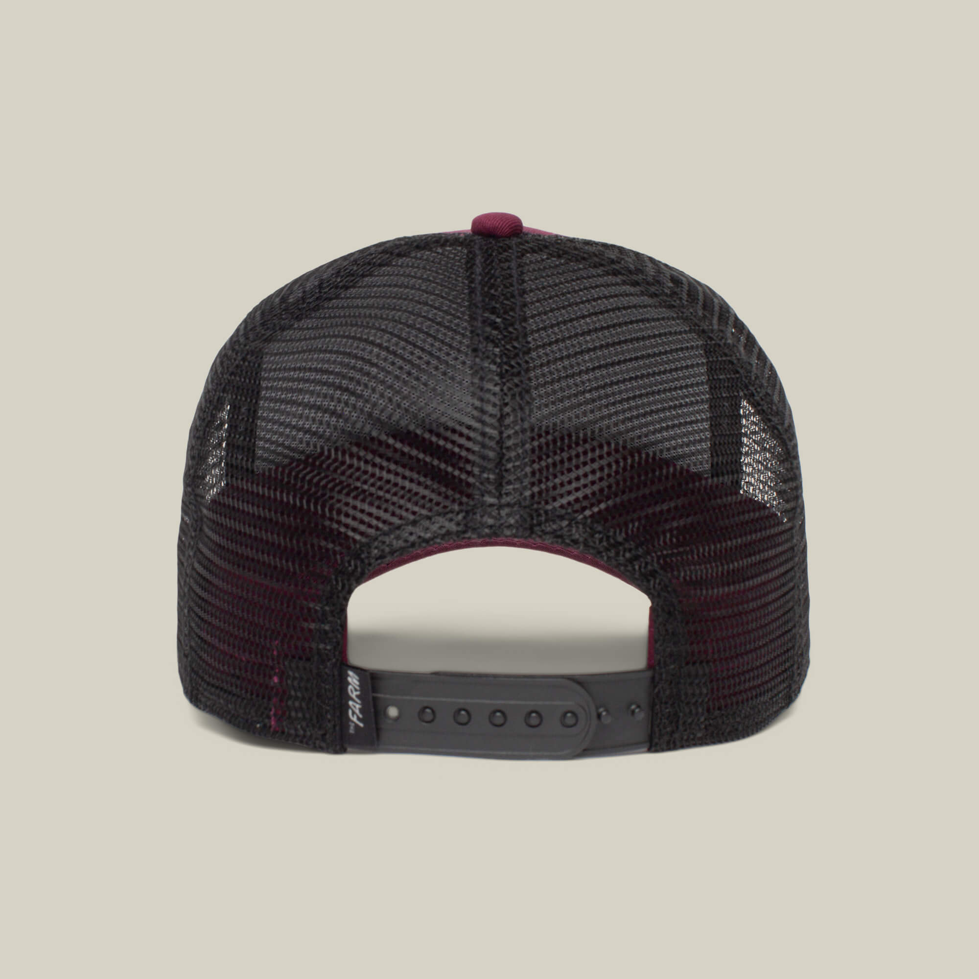 The image shows the back view of The Boss, a black mesh trucker hat by The Farm, featuring an adjustable snapback—ideal for your next movie theater outing.