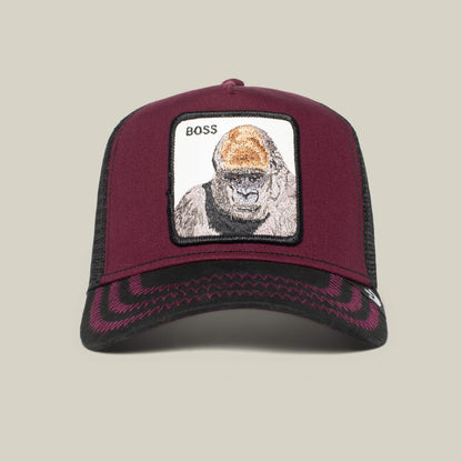 The Farm’s “The Boss” trucker hat features a maroon and black design with a patch showing an 800 pound gorilla and the word BOSS at the top left.
