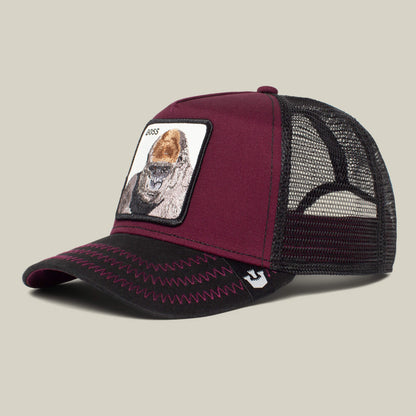 The Farm "The Boss" trucker cap features a maroon and black design with a mesh back and front patch of an 800-pound gorilla and BOSS text—an ideal accessory to add to your cart before your next movie night.