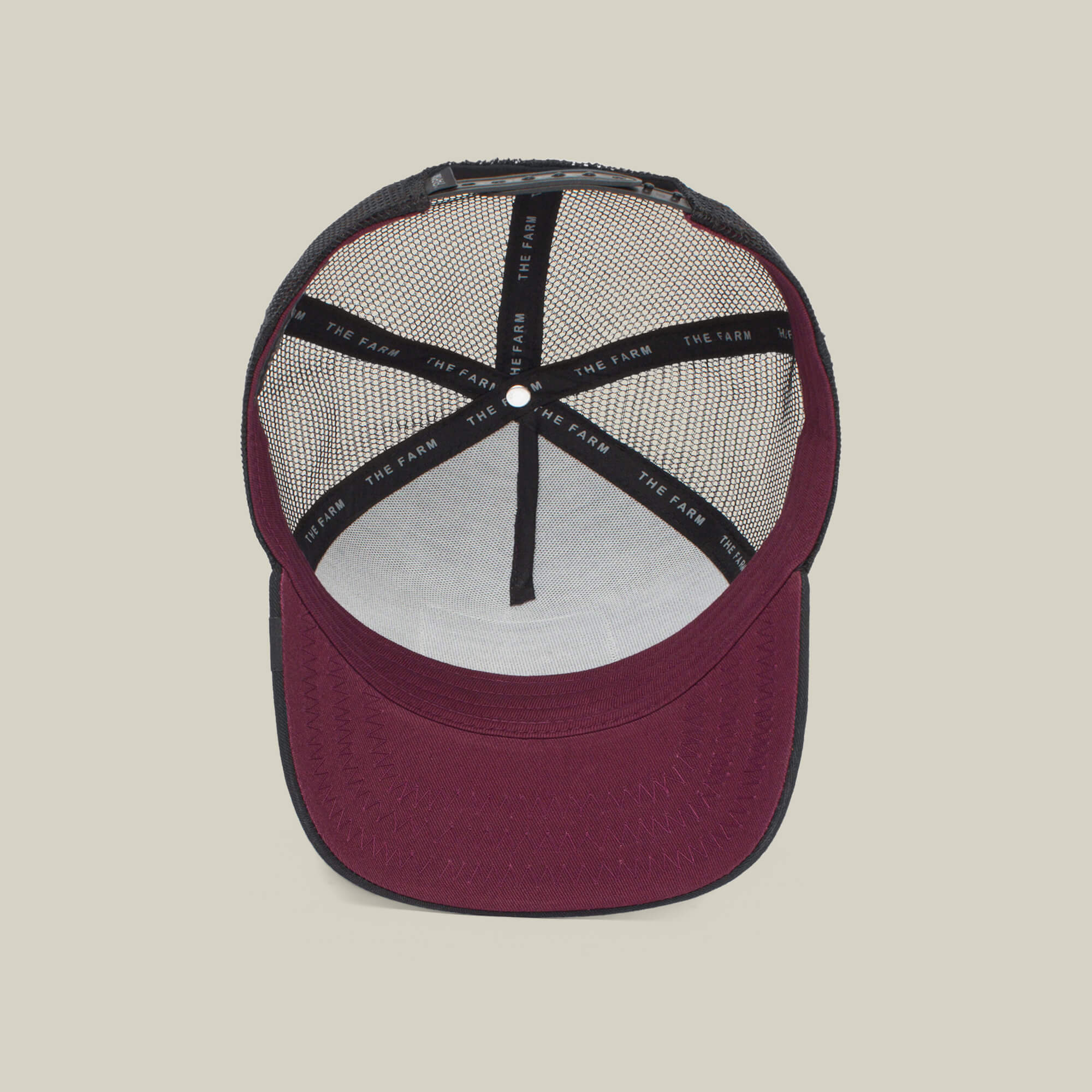The Boss by The Farm is a maroon and black trucker hat with a mesh back, interior seams, and a white sweatband labeled THE FARM—perfect for standing out in style. Add to cart now!.