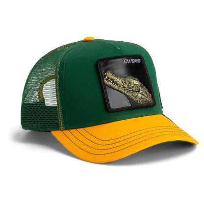 The Farm's The Oh Snap Alligator is a green and yellow trucker hat with a mesh back, front patch of an embroidered alligator head, and “OH SNAP” text. All sales are final.