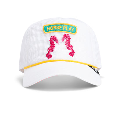 The Goorin Bros. Aquapals hat is a white mesh cap with a yellow-bordered Horse Play patch and two pink seahorses—perfect for fans of playful beach style or as a fun surf accessory.