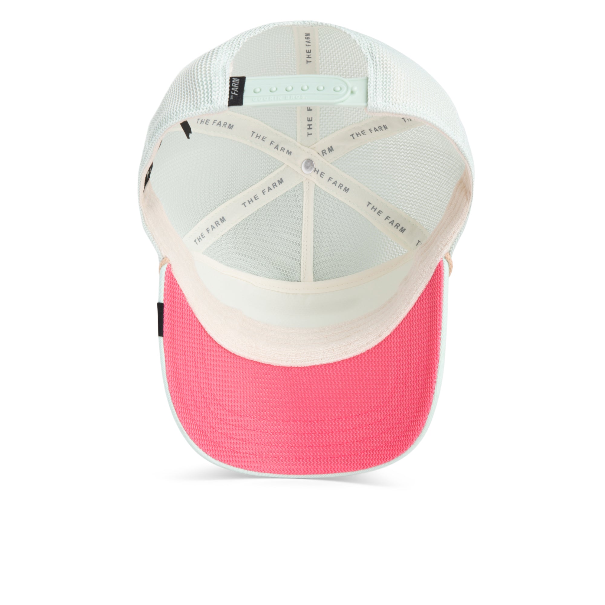 A top view of the Goorin Bros. Pick Yours trucker hat shows a pink brim, breathable mesh back, adjustable snap closure, and THE FARM branding on the interior seams.