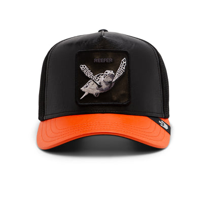 A black and orange trucker cap called Shell Smoke by The Farm, featuring a sea turtle patch labeled REEFER on the front; all sales are final.