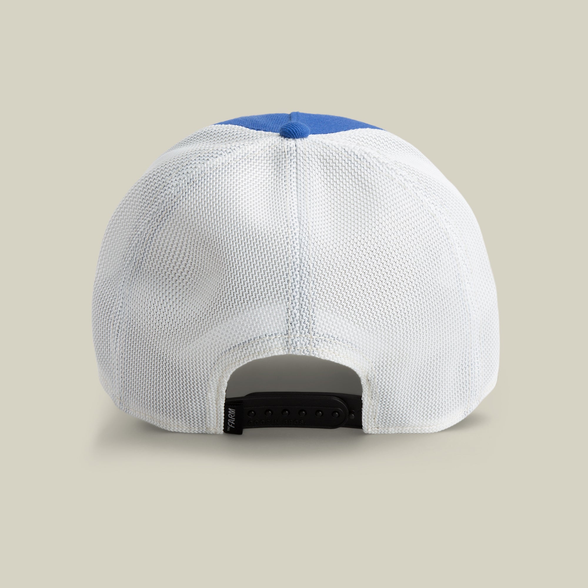 The Farm's Lionfish Heat cap features a white mesh back, blue top panel, and an adjustable black snapback closure. Viewed from the back. All sales are final.