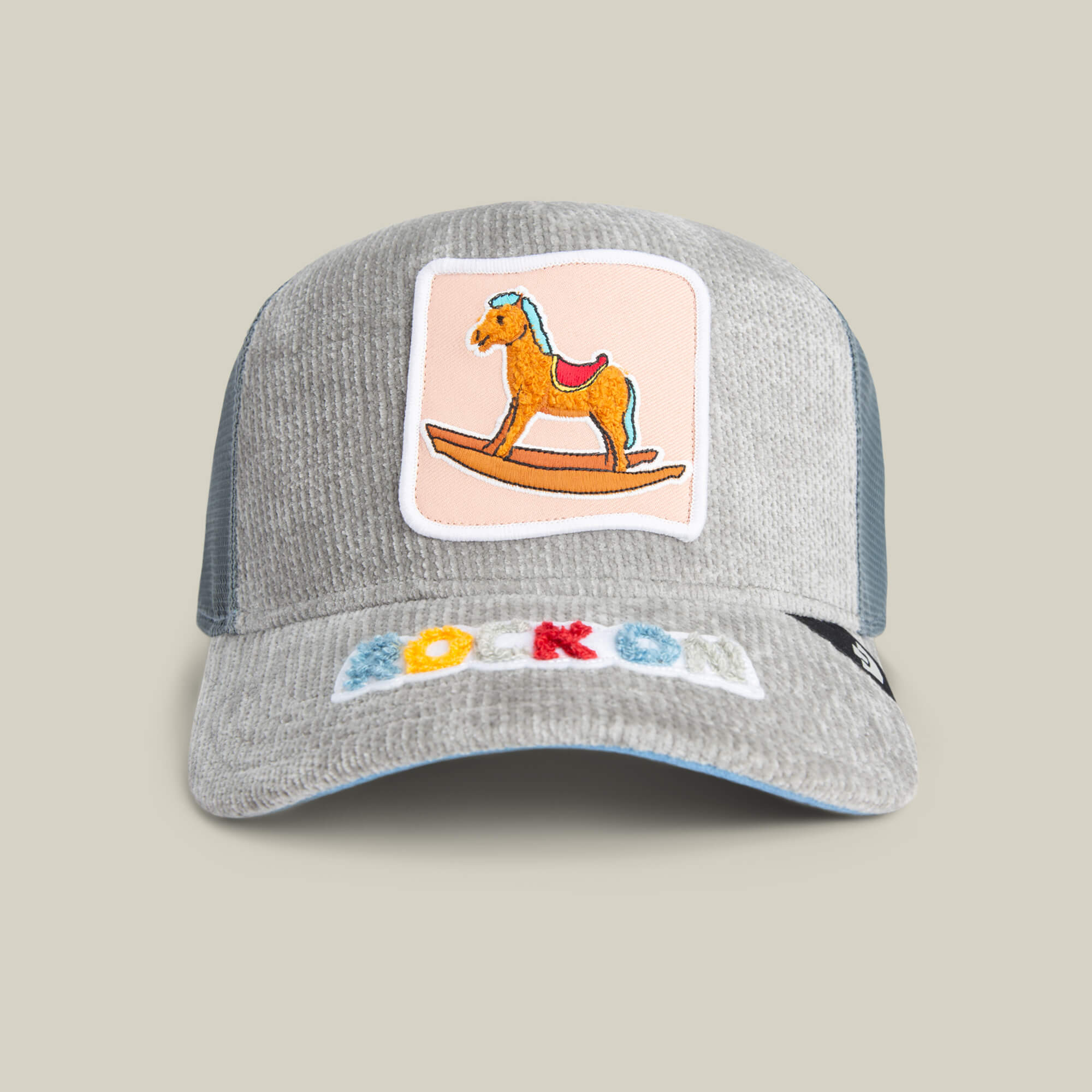 The Goorin Bros. Hobby Horse cap in SHADOW features a rocking horse patch on the front and “ROCKON” in colorful letters on the brim, blending streetwear style with nostalgic charm.