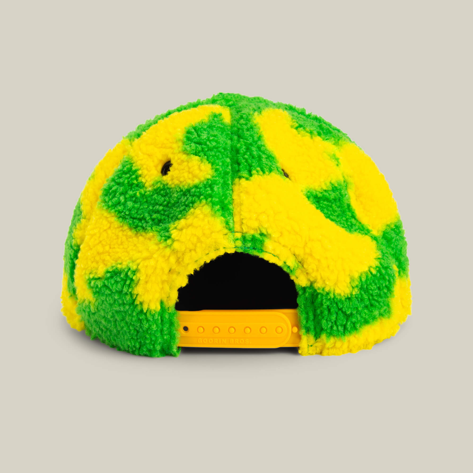 The Loose Cannon by Goorin Bros. is a fuzzy baseball cap with a neon green sherpa and yellow pattern, shown from the back with a yellow adjustable snap closure.