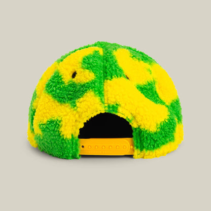 The Loose Cannon by Goorin Bros. is a fuzzy baseball cap with a neon green sherpa and yellow pattern, shown from the back with a yellow adjustable snap closure.