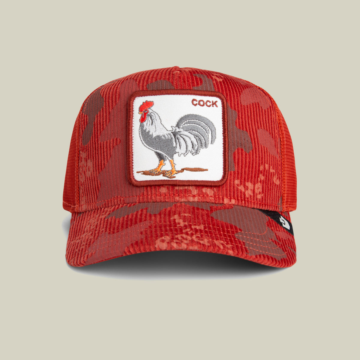 Goorin Bros. “Rooster Camo” trucker hat in SOLAR colorway, featuring a corduroy brim and a rooster patch with the word COCK above it, displayed against a plain beige background.