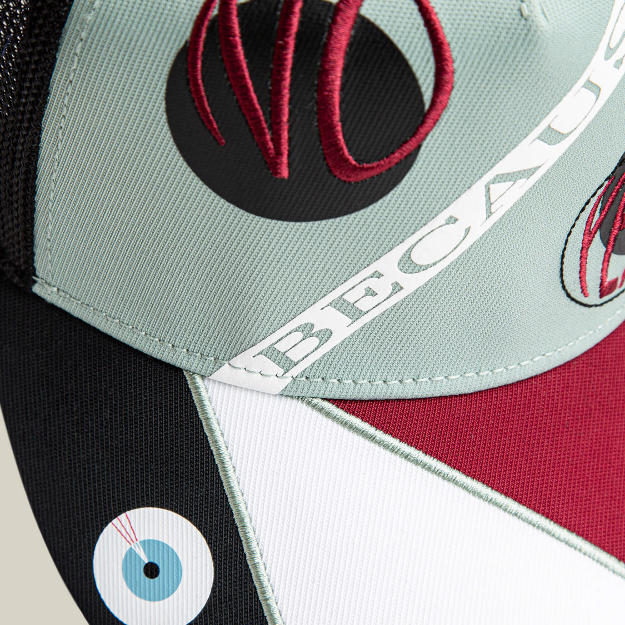 Close-up of the Goorin Bros. Means Agreed cap with geometric color blocks, embroidered "NO," "BECAUSE," and a blue eye—ideal to pair with your confident casual or agreement T-shirt.