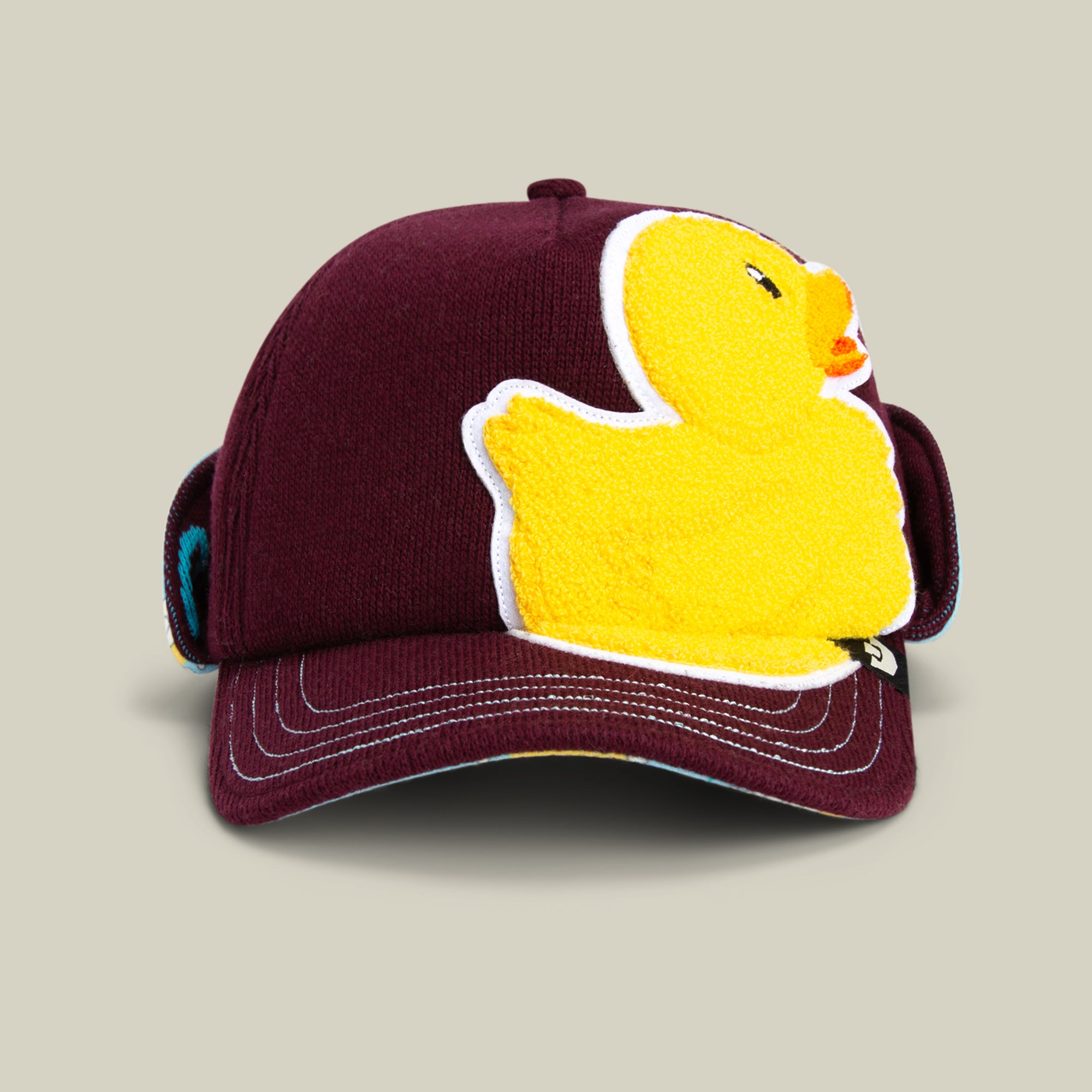 The Goorin Bros. F is for Duck trucker cap in DESIRE features a large yellow embroidered rubber duck on the front—an eye-catching and playful duck hat for any fun-loving style.