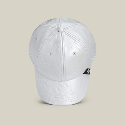 The Put a Panther On It cap by Goorin Bros. features white embossed fabric with subtle patterns, a black logo tag on the side, and offers a classic fit, displayed against a light beige background.