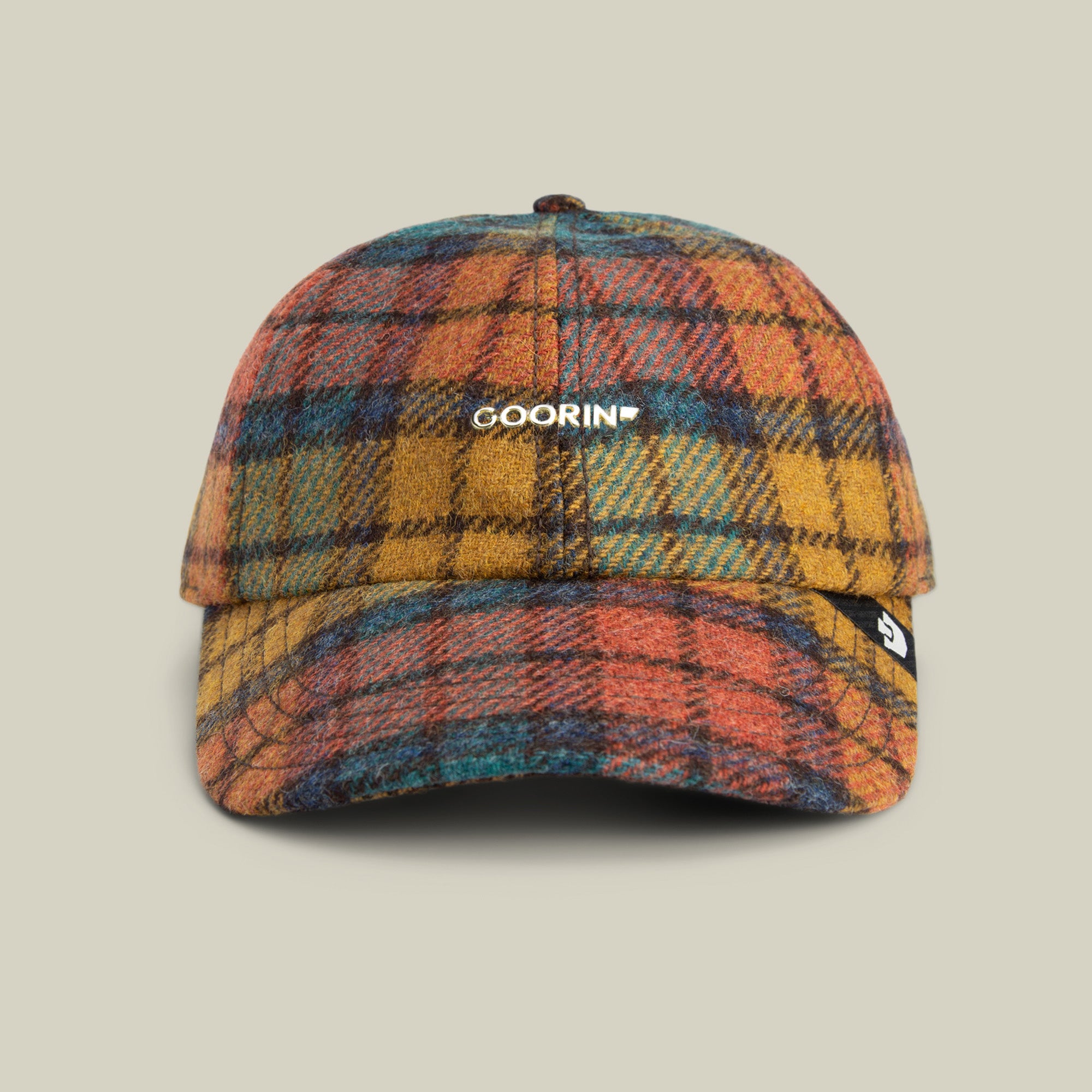 Front view of the Goorin Bros. Bespoke Wordmark baseball cap in MULTI COLOR, featuring a gold Goorin metal logo on the front and a small black side tag.