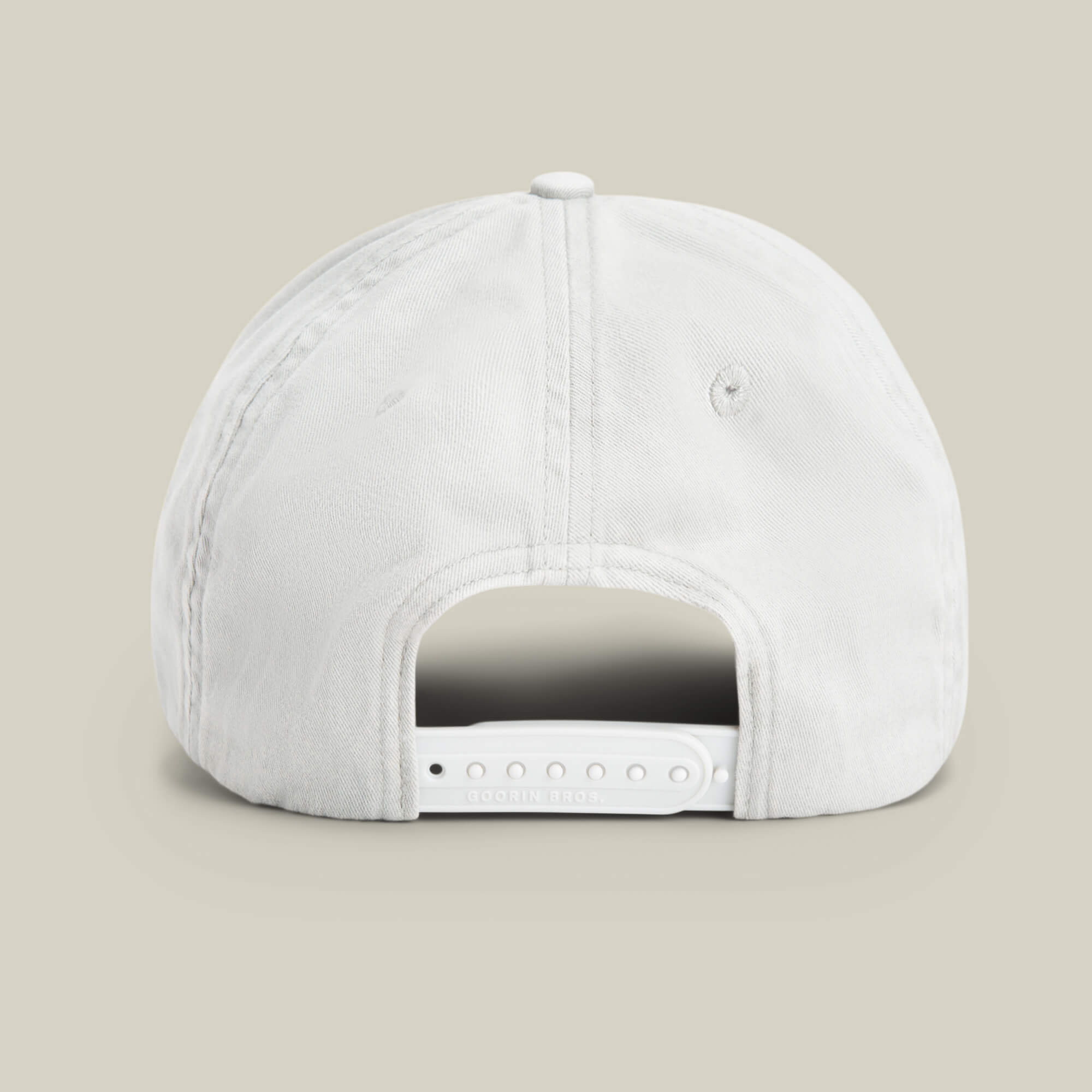 The Goorin Bros. Papa Cap Italiano in white, shown from the back with an adjustable snapback and stitched eyelets, is set against a light background—ideal for fans of classic vintage cap style.