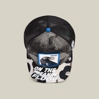 The “Techno” hat by Goorin Bros. is a black mesh trucker with a raven patch, blue button, and “ON THE FREAKIN FLOOR” on the brim—ideal for raves or standout festival style.