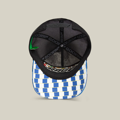 The Goorin Bros. Techno trucker hat features a black mesh back and blue-and-white checkered brim, viewed from above to reveal the inside and branding—a standout festival or rave accessory for bold techno style.