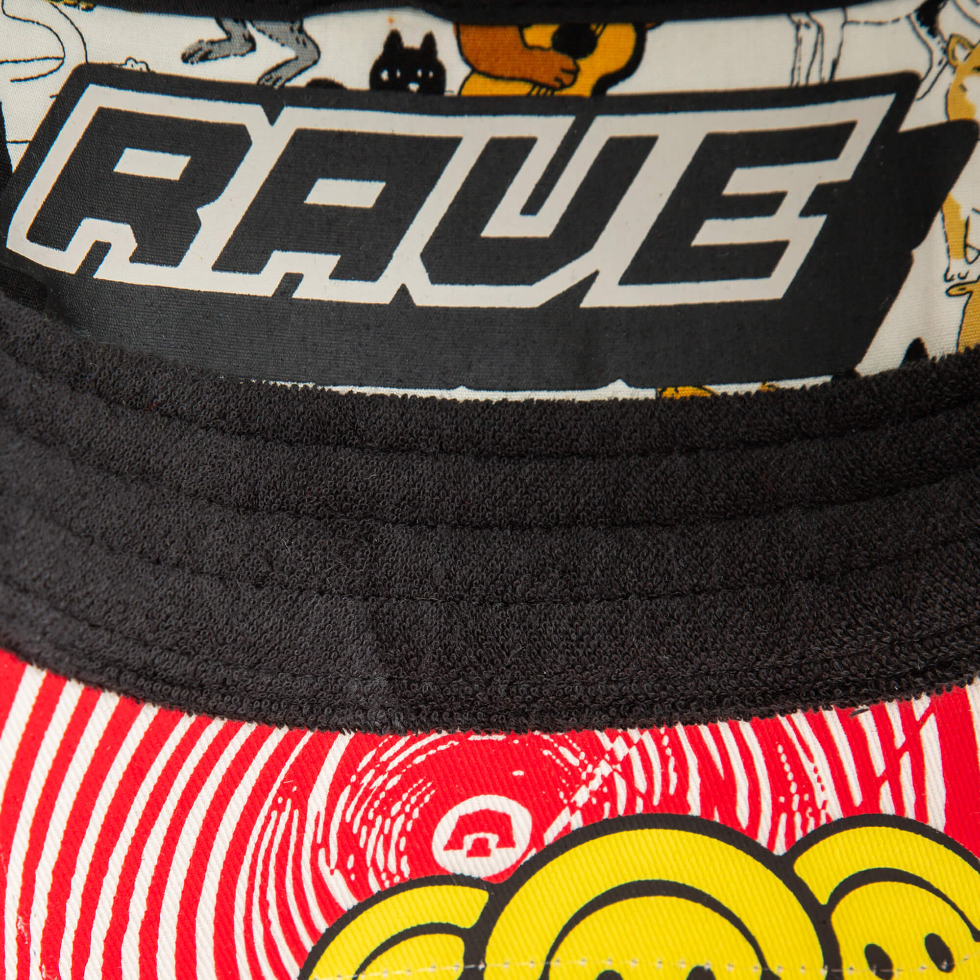 Close-up of the Drum and Bass hat by Goorin Bros., featuring cartoon animal art, red and white swirls, yellow smiley faces—perfect for any bass music festival.